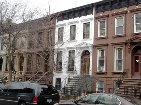 Brownstone and white stone row houses with stoops on Prospect Place, Brooklyn