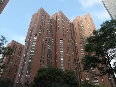 Red brick residential high-rise towers seen from below in Manhattan