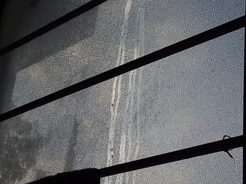 Condensation beading on the inside of a window pane