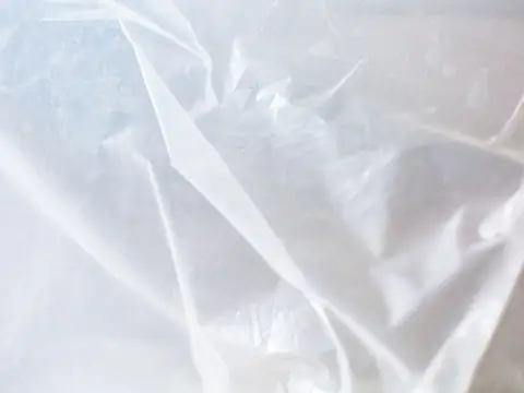 Clear plastic sheeting draped over surfaces to keep dust in one place during work