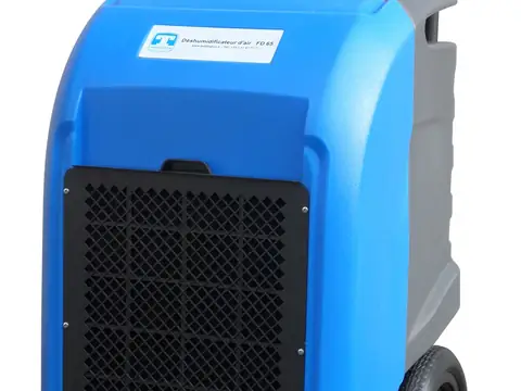 A blue portable dehumidifier on wheels standing on a floor